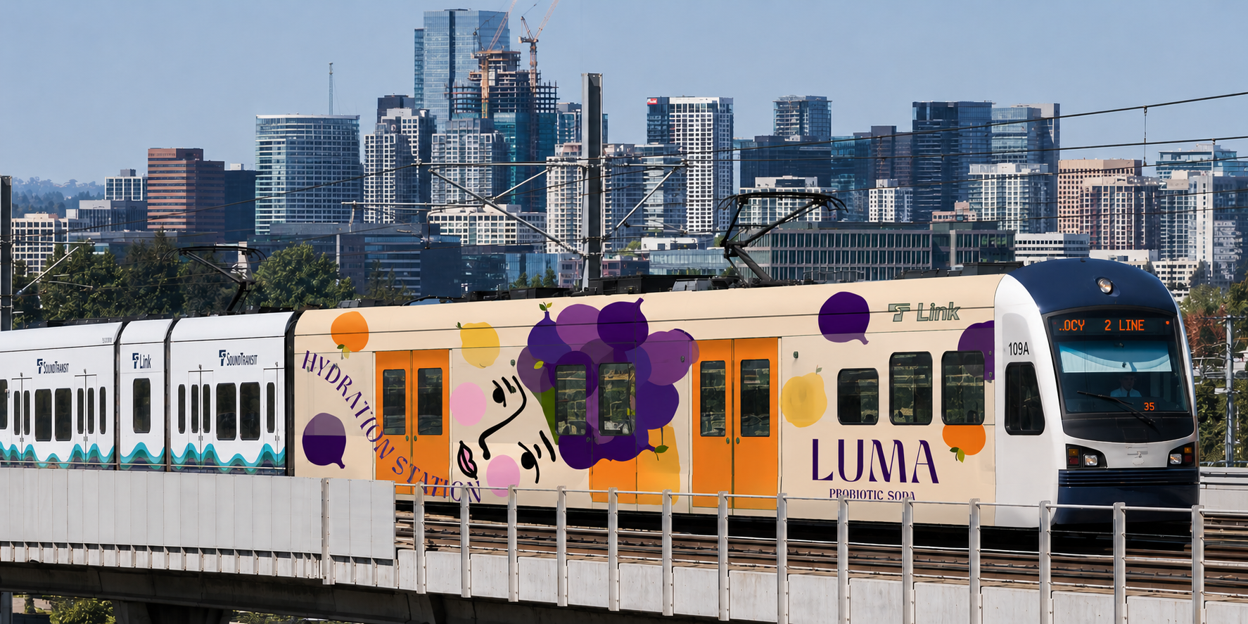 LUMA branded Link light rail train wrap at Westlake Station with purple flowers and orange doors